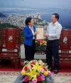 Mr. Ho Quoc Dung (right) giving a gift to Ms. Nguyen Phuong Nga